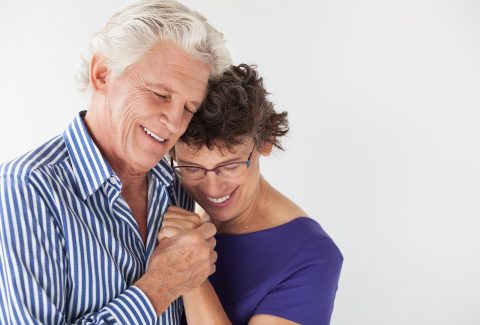 Affectionate senior couple embracing and dancing
