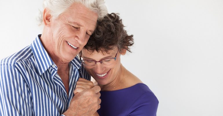 Affectionate senior couple embracing and dancing
